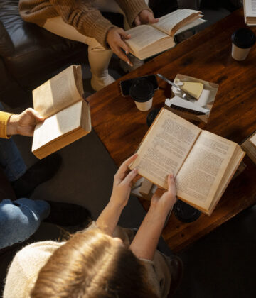 high-angle-people-reading-togeth